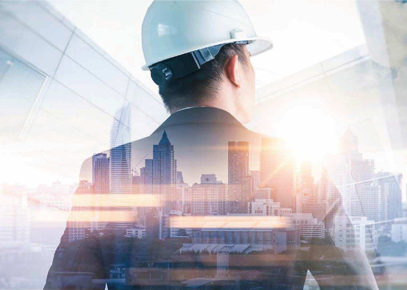 A professional engineer in a suit and hard hat, standing with his back to a city skyline, symbolizing leadership and construction.